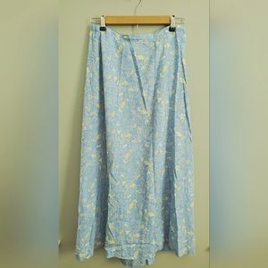Maxi skirt, light blue with design of yellow flowers and green leaves. Size M